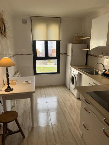 a kitchen with a table and a sink and a window at Casa Montaña de Riaño y Picos de Europa I in Riaño