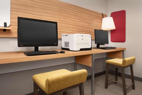 a desk with a computer and a printer on it at Hilton Garden Inn Solomons in Dowell