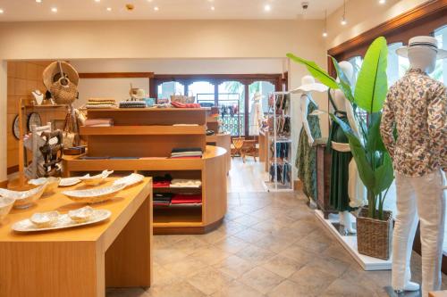a clothing store with a woman standing in a room at Hilton Mauritius Resort & Spa in Flic-en-Flac