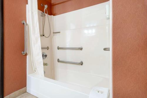 a bathroom with a shower with a white tub at Quality Inn Bemidji in Bemidji