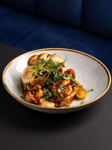 a plate of food with mushrooms and vegetables at Radisson Blu Hotel Wroclaw in Wrocław