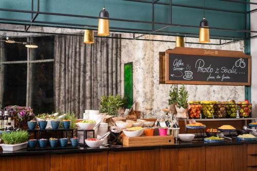a food counter with bowls and plants on it at Radisson Blu Hotel Wroclaw in Wrocław