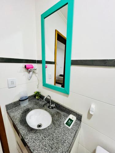 a bathroom with a sink and a mirror at H34 Hotel in Guarulhos