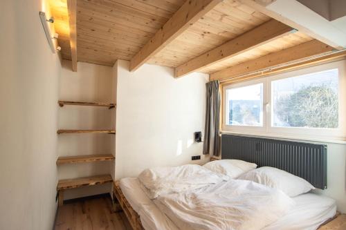 a bed in a room with a window at Hostel oder Ferienwohnung 1-16 Personen im BLAUEN HAUS in Fehmarn