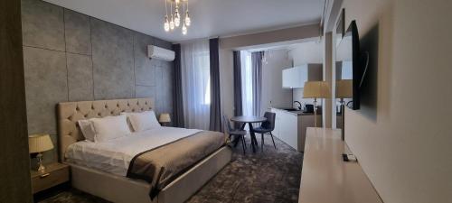 Schlafzimmer mit einem Bett, einem Tisch und einem Schreibtisch in der Unterkunft Hotel Building Stefan Resort I in Mamaia Nord – Năvodari