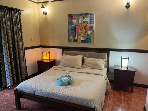 a bedroom with a bed with a blue bowl on it at Big Apple Dive Resort in Puerto Galera