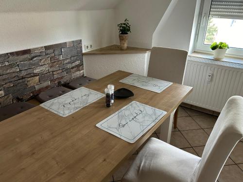 a wooden table with some drawings on it at Apartment Sonnenblick in Mittelbach Chemnitz- Voll ausgestattet, ruhig und zentral wohnen in Chemnitz