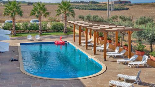 a swimming pool with a red float in the middle at Hotel Donna Carmela Sede Unica a Sciacca in Sciacca