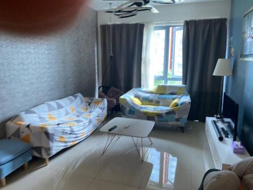 a room with two beds and a table with a laptop at Condo in Klang. Nordica Gravit8 in Klang