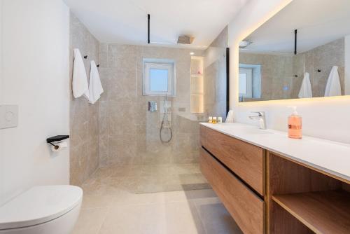 a bathroom with a toilet and a sink and a shower at Villa Ana to rent in Puerto Pollensa by JS Villas in El Port