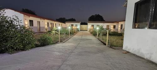 a driveway leading to a building at night at Neelkanth Hotel and Restaurant in Dabhoi