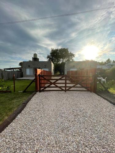 a fence with a gate in front of a house at La Cambicha in Uribelarrea