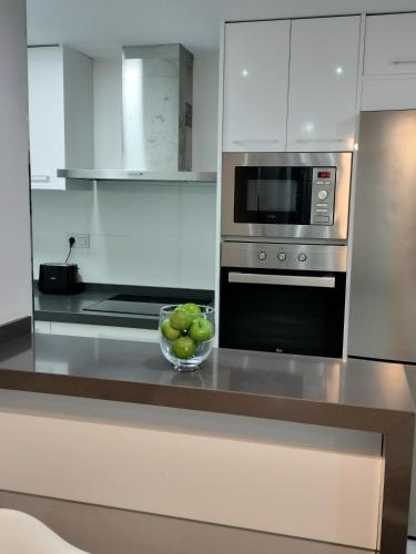 a kitchen with a bowl of fruit on a counter at NAUTILUS in Torrevieja
