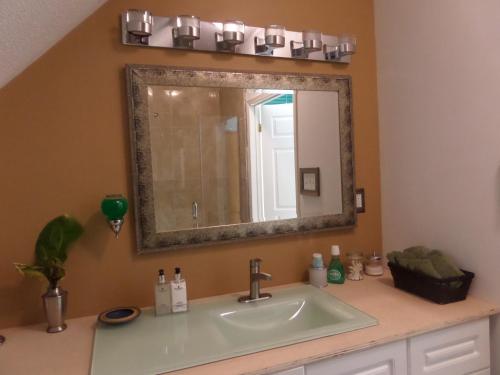 a bathroom with a sink and a mirror at Inn on the Moraine in Caledon