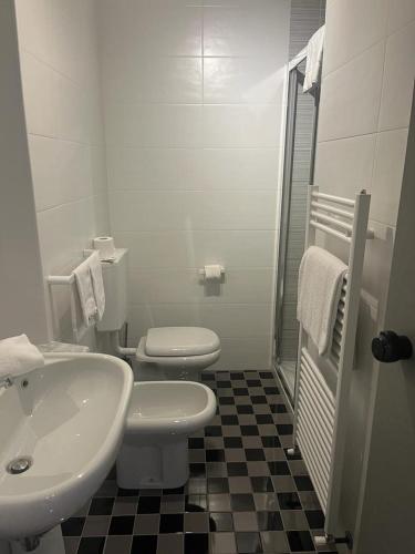 a bathroom with a sink and a toilet and a shower at Green Hotel in Vergiate