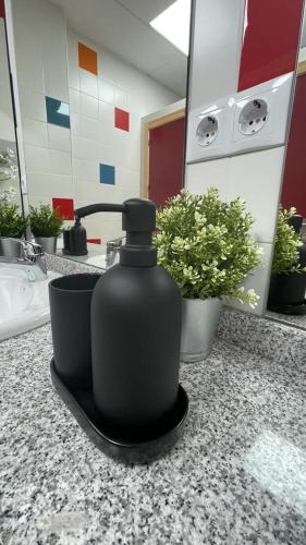 a black soap dispenser sitting on a counter in a bathroom at La Antigua Editorial in Pozuelo de Zarzón