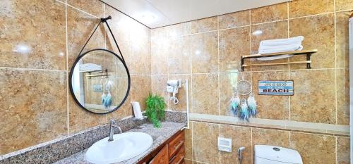 a bathroom with a sink and a mirror at Dreamland Paradise Resort in Batangas City