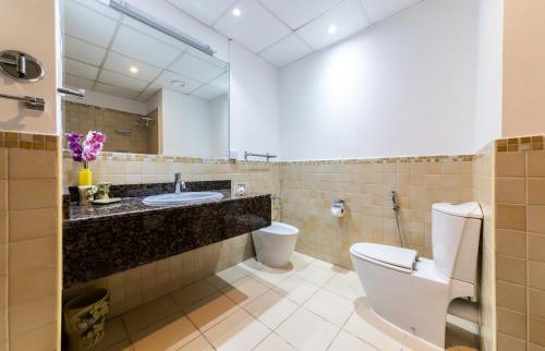 a bathroom with a toilet and a sink at Maison Privee - Premium Apt in the Heart of JBR Beach, Dubai in Dubai