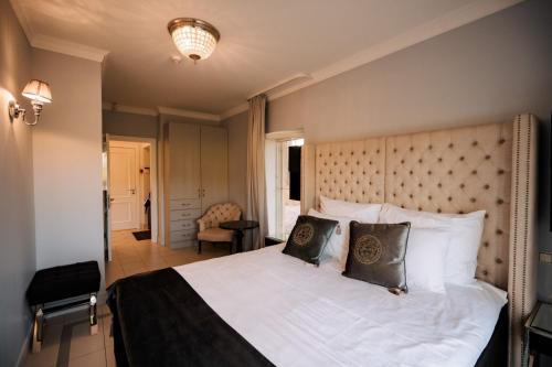 a bedroom with a large bed with white sheets and pillows at Silene Resort & Spa in Silene