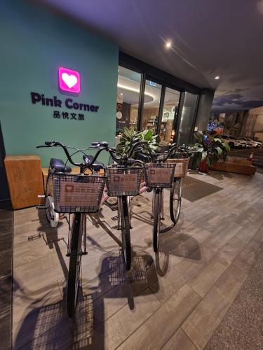 three bikes with baskets on them in a store at Hualien Pink Corner Hotel in Hualien City