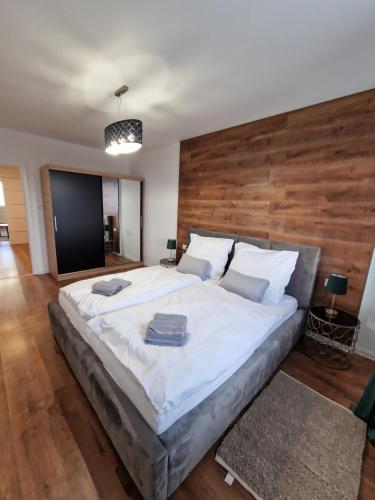 um quarto com uma cama grande e uma cabeceira em madeira em Luxusný byt, 5 Minút peši do Centra em Košice