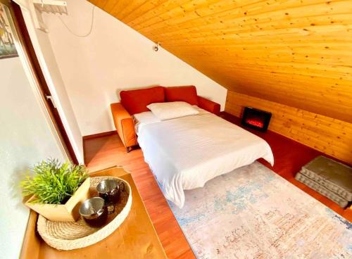 a small bedroom with a bed in a attic at [Chalet di lusso]Vista lago + Sauna in Cimo