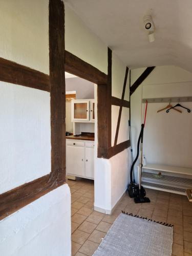 a kitchen with wooden beams on the walls at Gästehaus Lichtblick in Herrenhof