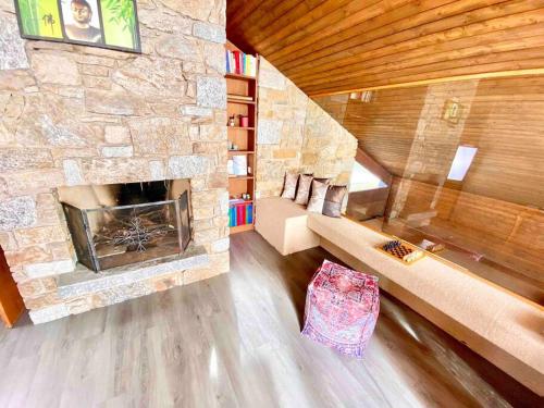 una sala de estar con una gran chimenea de piedra. en [Chalet di lusso]Vista lago + Sauna, en Cimo