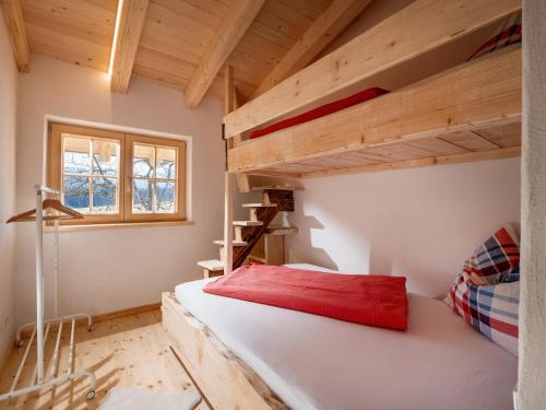 a bedroom with a bunk bed and a loft at Ferienhaus Weberhof in Hopfgarten im Brixental