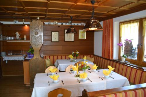 a dining room with two tables in a restaurant at Haus Binder in Ried im Zillertal