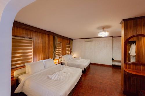 a hotel room with two beds in a room at LuangPrabang Center Hotel in Luang Prabang