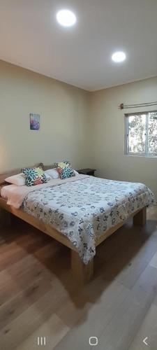 a bedroom with a large bed in a room at El Roble cabañas tepa in Pucón