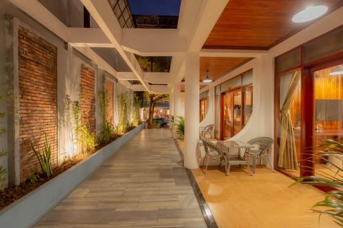 a hallway of a house with a table and chairs at LuangPrabang Center Hotel in Luang Prabang