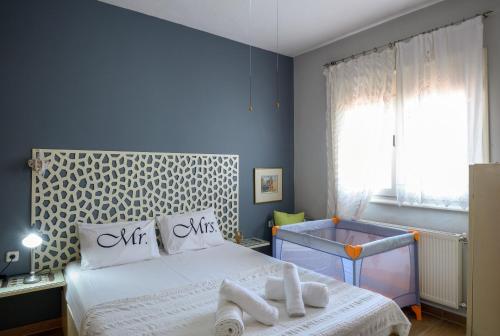 a bedroom with a bed with towels on it at Sophia houses by the sea in Nea Kalikratia