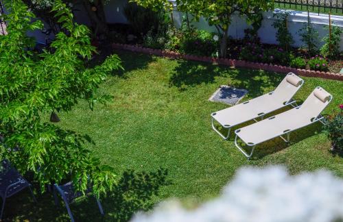an overhead view of two lounge chairs in a yard at Sophia houses by the sea in Nea Kalikratia