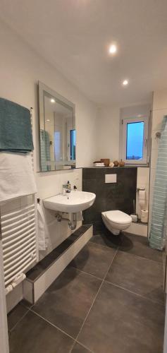 a bathroom with a sink and a toilet at Ein Haus zum Träumen in Bensheim