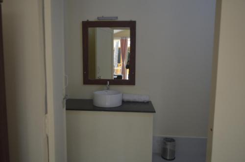 a bathroom with a sink and a mirror at Taste of Nature in Canacona