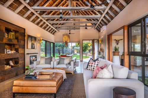a living room with a couch and a table at Marula Sunrise Lodge, Mjejane Private Game Reserve in Hectorspruit