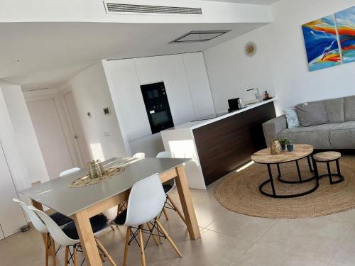 Una cocina y una sala de estar con mesa y sillas. en Casa del Mar Menor, en San Javier