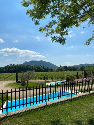 a swimming pool in a yard with a fence at Agriturismo Corte Patrizia in Caprino Veronese