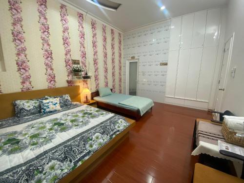 a bedroom with two beds and a couch in it at Villa homestay Misa in Phan Thiet
