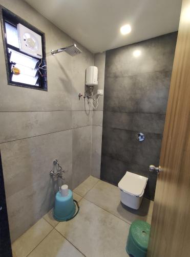 a bathroom with a shower with a toilet and a window at HOTEL SHREE RAM in Rājpīpla