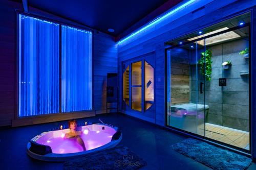 a bathroom with a tub with a woman in it at Rien Que Nous in Moyeuvre-Grande