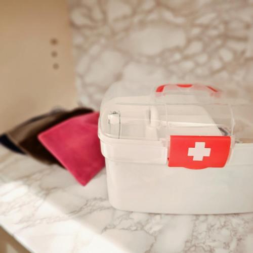 a white container with a red cross on it on a counter at ueno minowa 502 in Tokyo