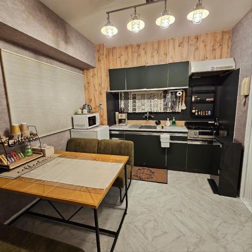 a kitchen with a table and a counter top at ueno minowa 502 in Tokyo