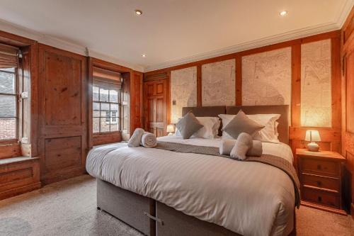 a bedroom with a large bed with wooden walls at Hewitt's Restaurant & Rooms in Newport