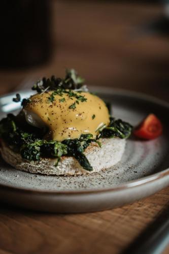 a fried egg on a plate on a table at kerii - adults boutique hotel in Saalbach Hinterglemm