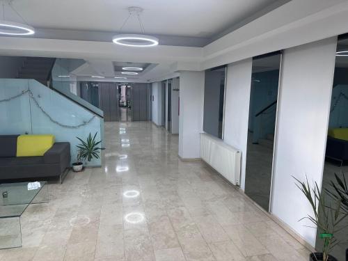 an empty hallway in an office building with a couch at Forest View Pipera in Voluntari