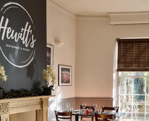 a dining room with a table and chairs at Hewitt's Restaurant & Rooms in Newport