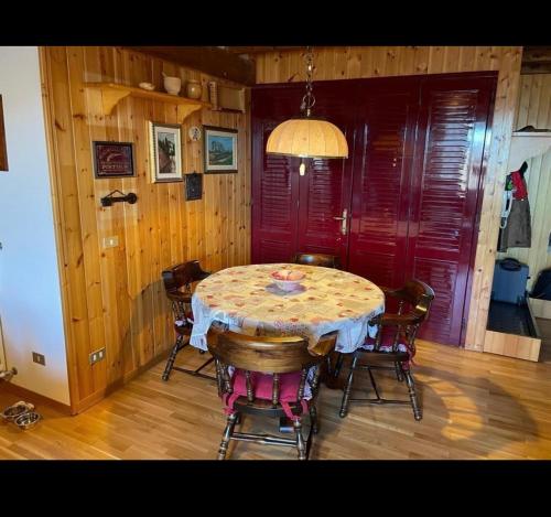 a dining room with a table and some chairs at Appartamento Abetone Vacanze in Abetone